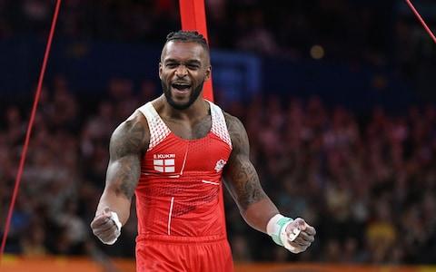 Courtney Tulloch of England celebrates his routine on the Rings 